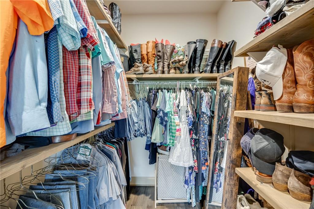 5911 Bent Tree Way Clermont, GA 30527 - Photo 43 of 56 a view of walk in closet with clothes and shoes