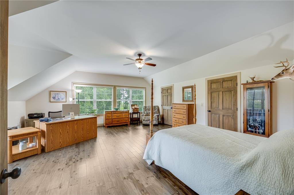 5911 Bent Tree Way Clermont, GA 30527 - Photo 46 of 56 a bedroom with furniture and a wooden floor