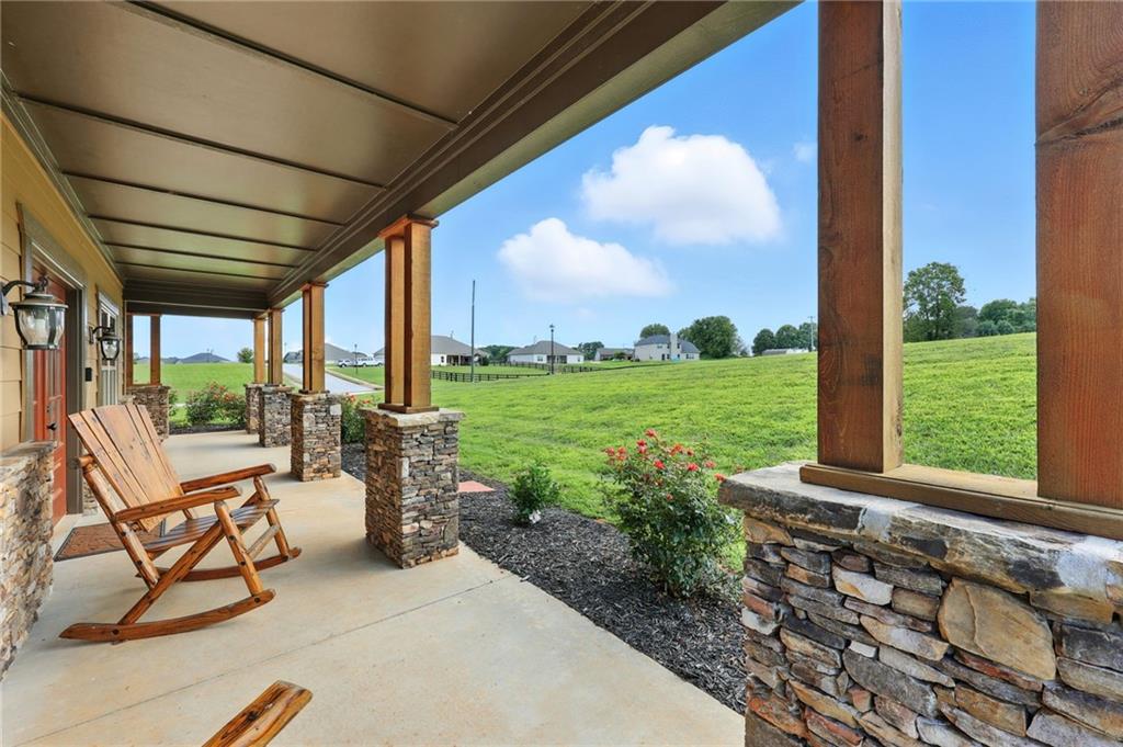 5911 Bent Tree Way Clermont, GA 30527 - Photo 5 of 56 a view of a porch with furniture and garden