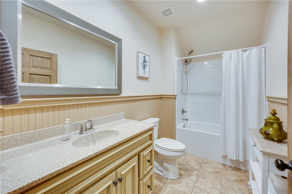 5911 Bent Tree Way Clermont, GA 30527 - Photo 51 of 56 a bathroom with a granite countertop sink toilet and shower