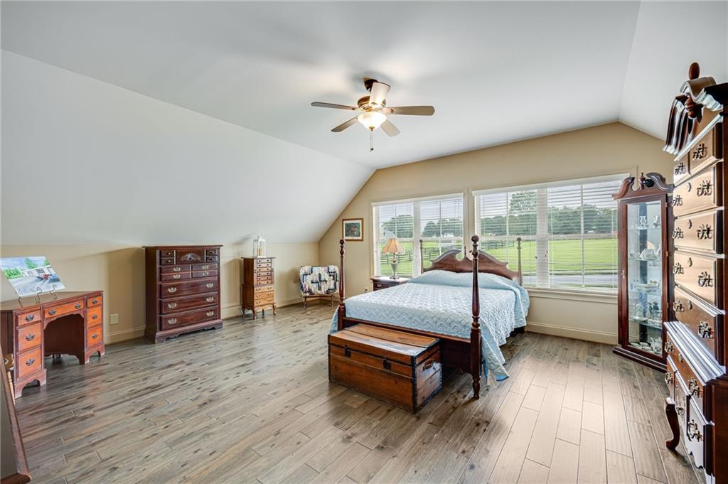 5911 Bent Tree Way Clermont, GA 30527 - Photo 52 of 56 a bedroom with furniture wooden floor and fan
