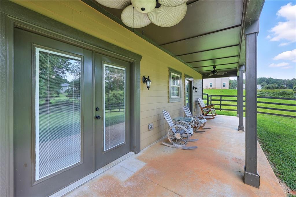 5911 Bent Tree Way Clermont, GA 30527 - Photo 9 of 56 a view of a porch with chairs and backyard
