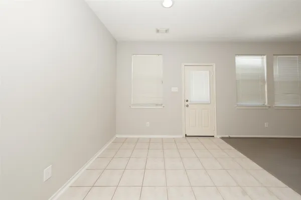an empty room with white wall and closet