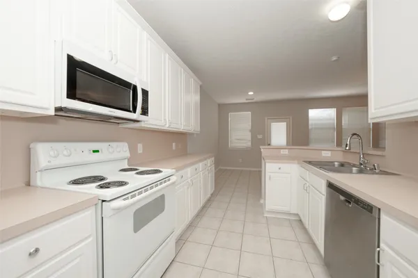a kitchen with stainless steel appliances granite countertop a sink and a stove