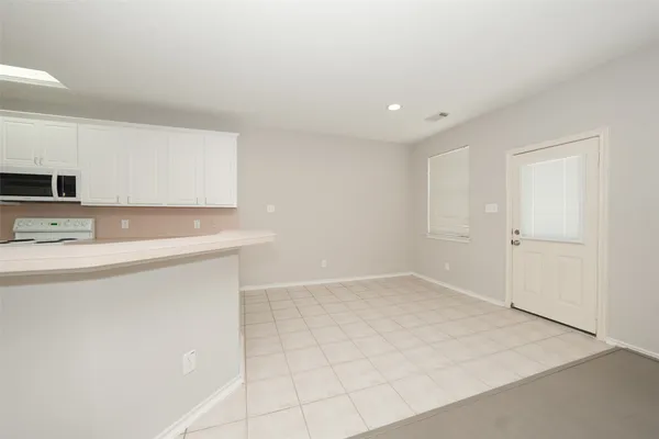 a view of kitchen with stainless steel appliances cabinets