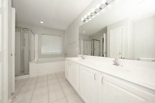 a bathroom with a bathtub a sink and a mirror
