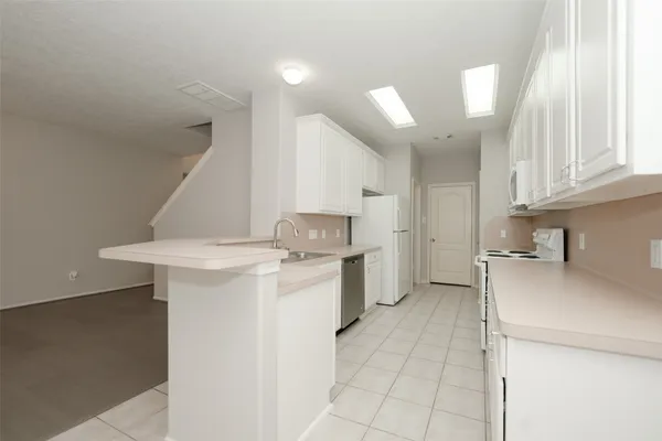 a kitchen with a sink cabinets and appliances