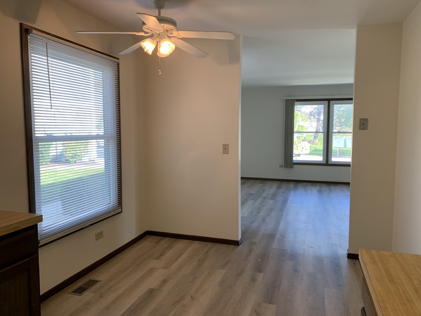 1068 Glouchester Harbor, Unit 1068 Schaumburg, IL 60193 - Photo 11 of 26 a view of empty room with wooden floor and fan