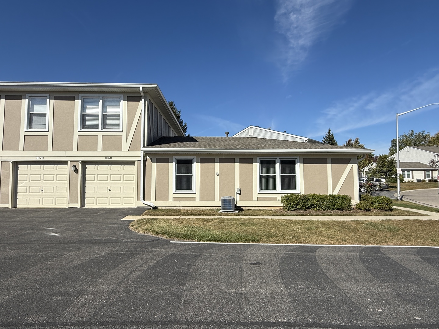 1068 Glouchester Harbor, Unit 1068 Schaumburg, IL 60193 - Photo 26 of 26 a front view of a house with a garden