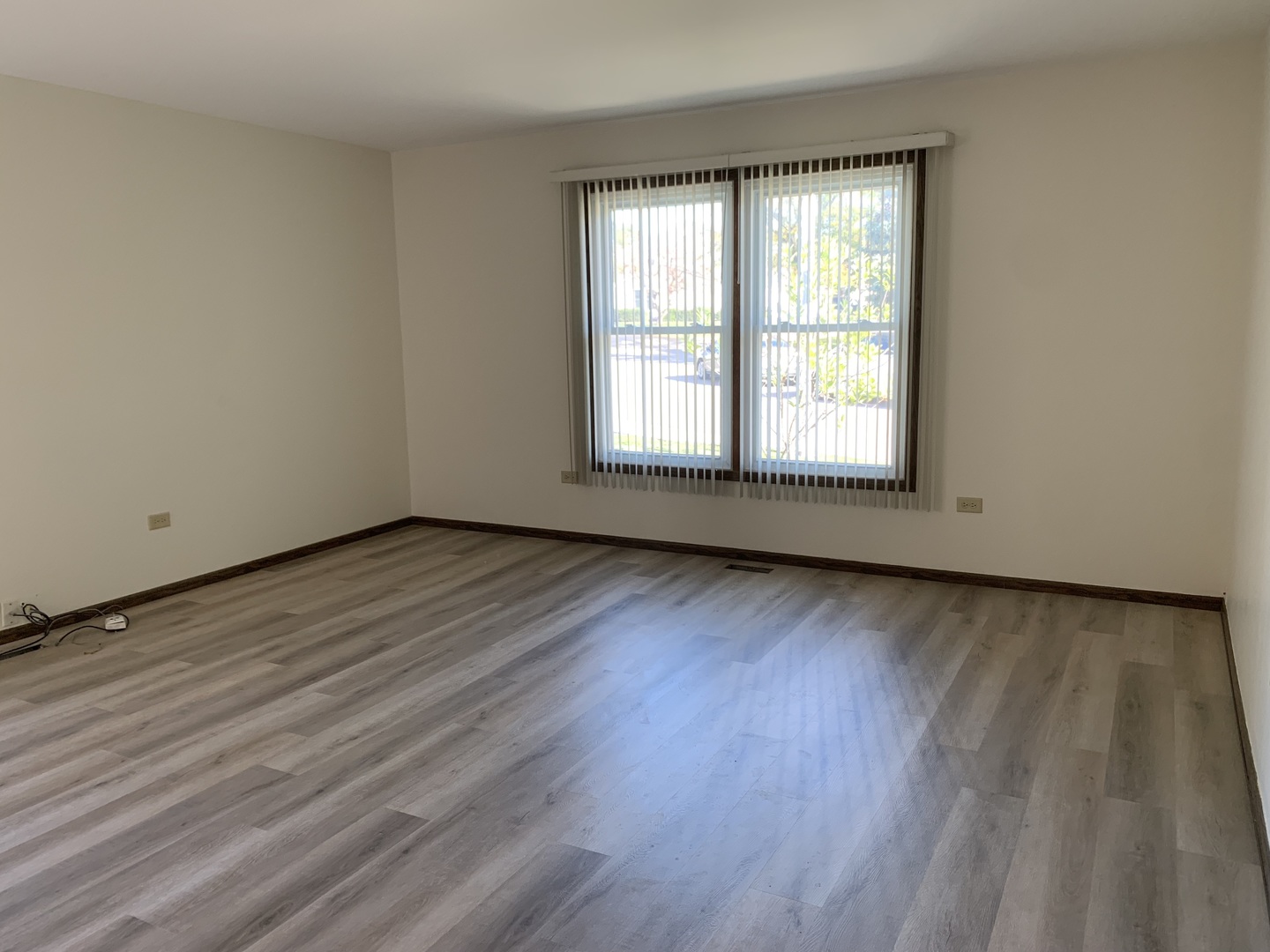 1068 Glouchester Harbor, Unit 1068 Schaumburg, IL 60193 - Photo 3 of 26 a view of an empty room and wooden floor and window
