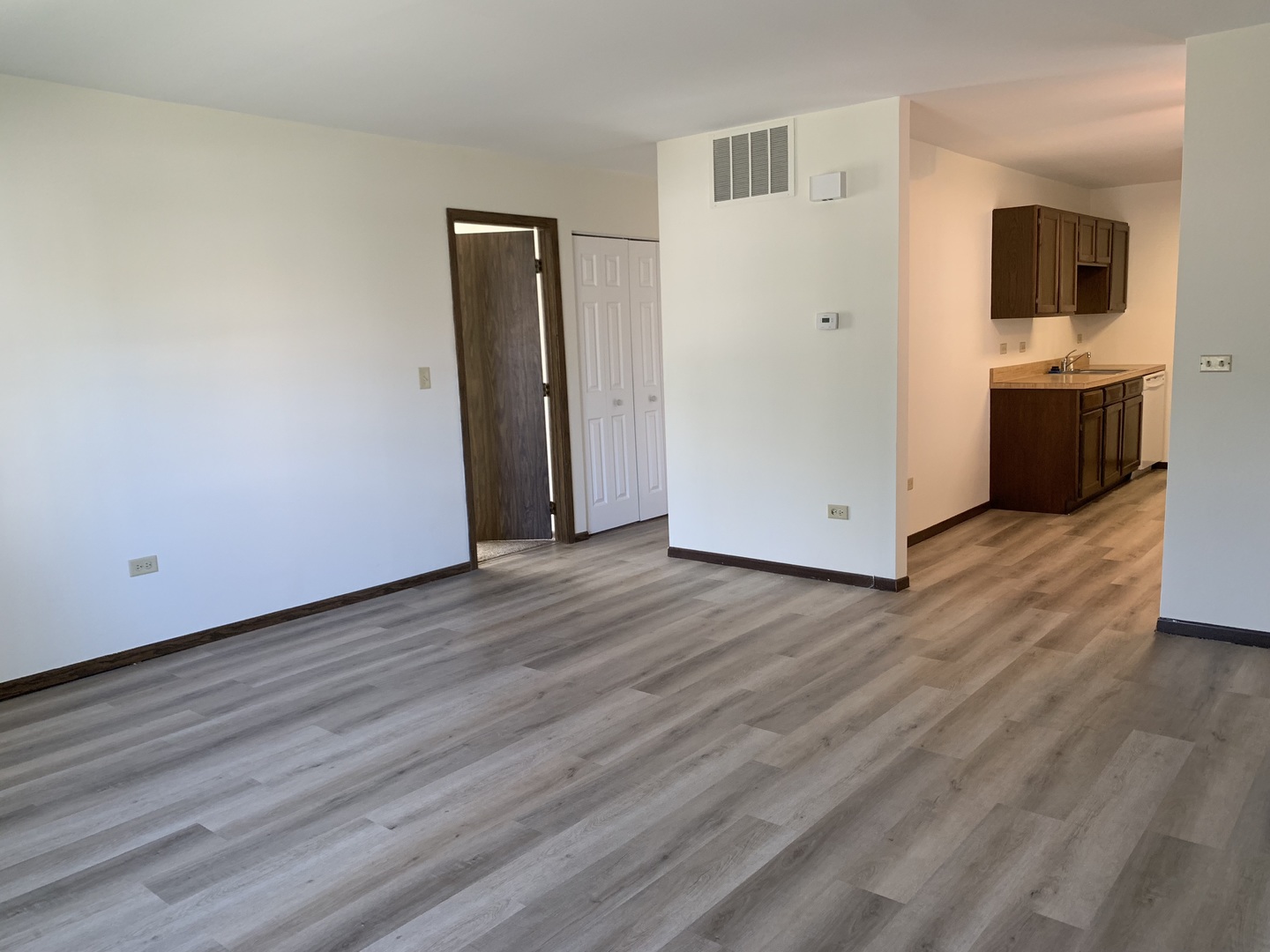 1068 Glouchester Harbor, Unit 1068 Schaumburg, IL 60193 - Photo 4 of 26 a view of a kitchen with wooden floor and a sink