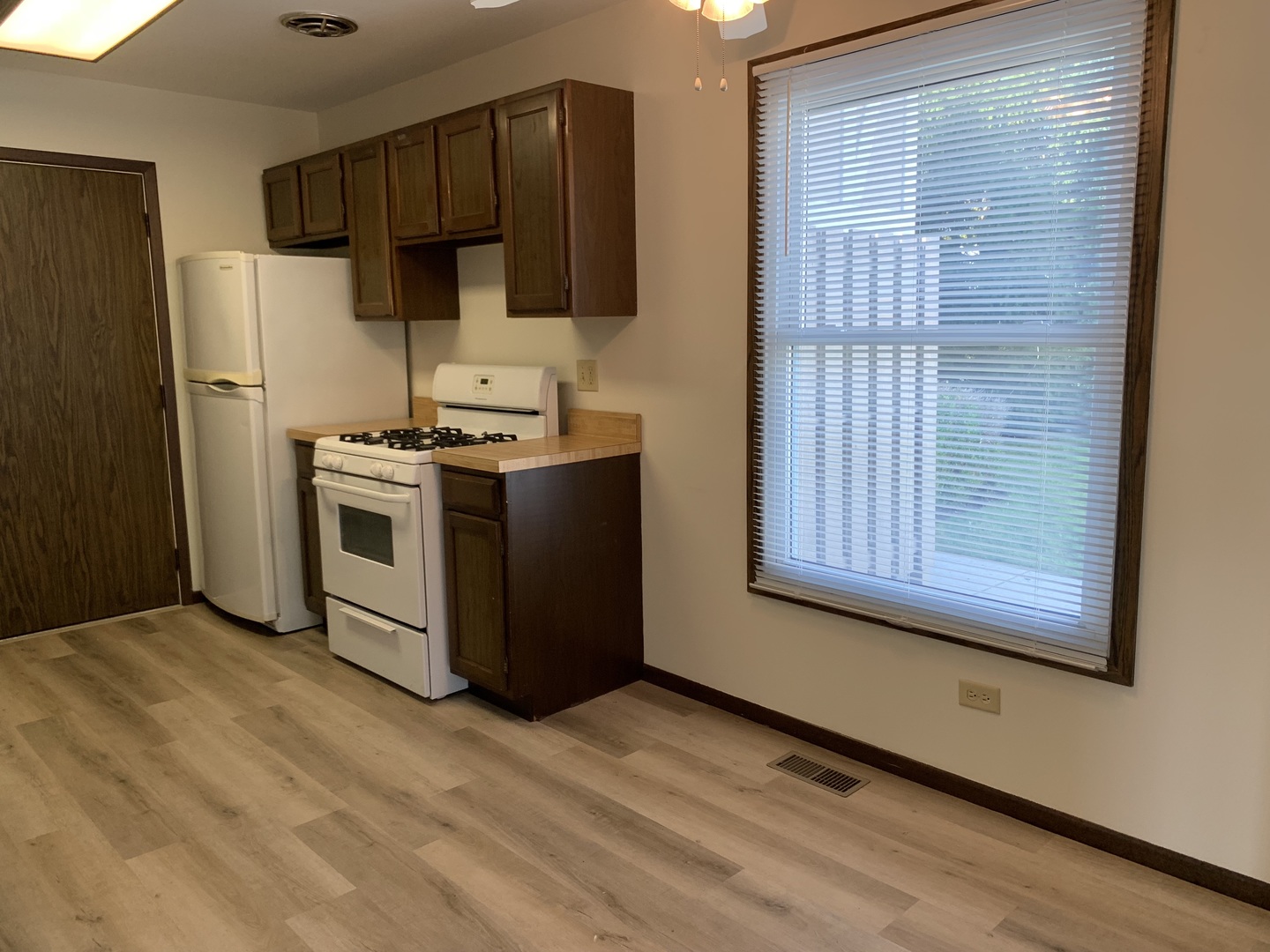 1068 Glouchester Harbor, Unit 1068 Schaumburg, IL 60193 - Photo 9 of 26 a kitchen with wooden cabinets and a stove top oven