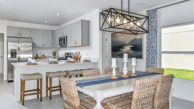 a kitchen with stainless steel appliances granite countertop a sink and a refrigerator