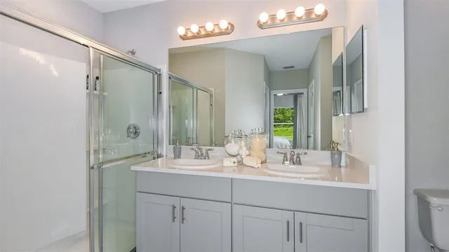 a bathroom with a sink double vanity and a mirror