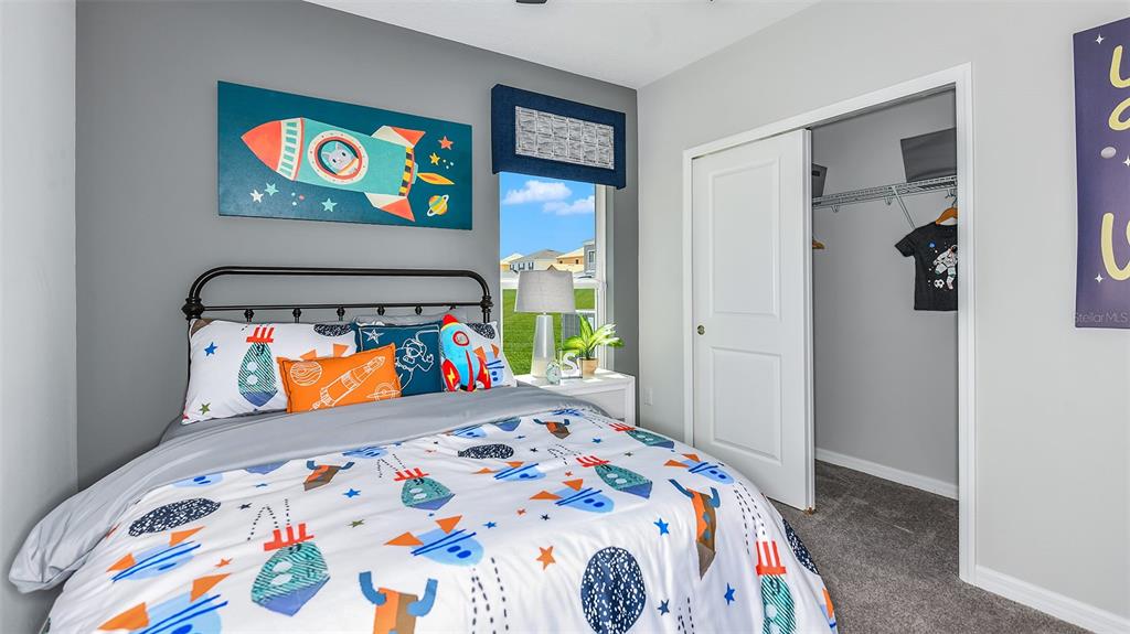 13709 Shellmore Avenue Palmetto, FL 34221 - Photo 16 of 17 a bed room with a bed and a painting on the wall