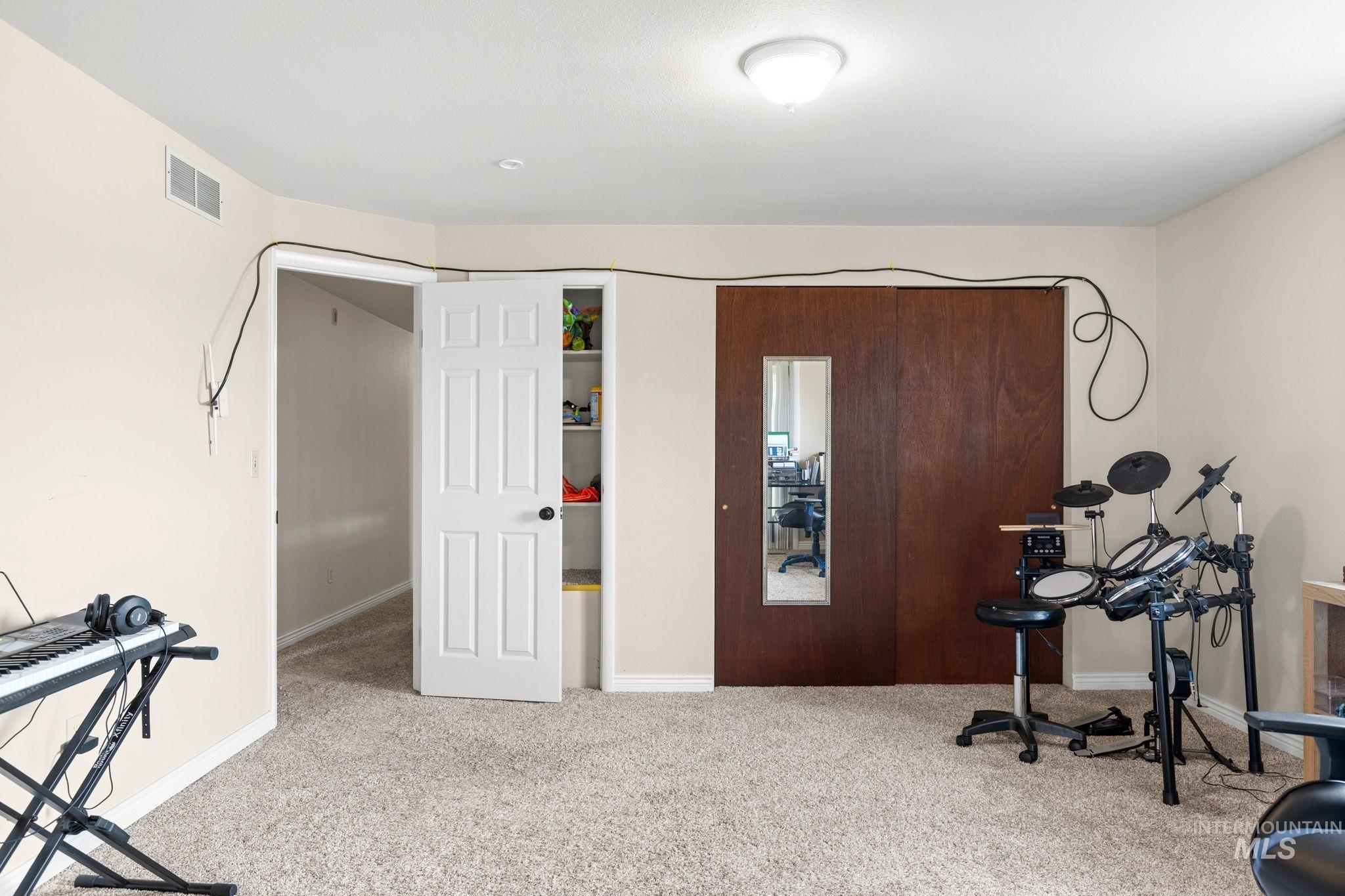 18338 Pride Lane Caldwell, ID 83607 - Photo 29 of 50 Carpeted interior space featuring neutral wall paint, white trim, and a white six-panel door