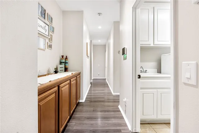 a view of a hallway with wooden floor