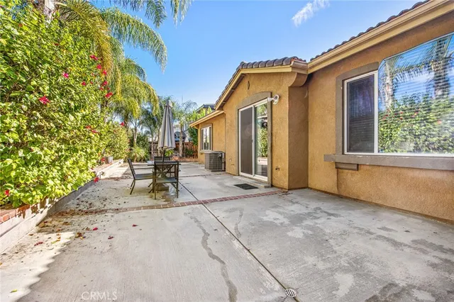 a view of backyard with a patio