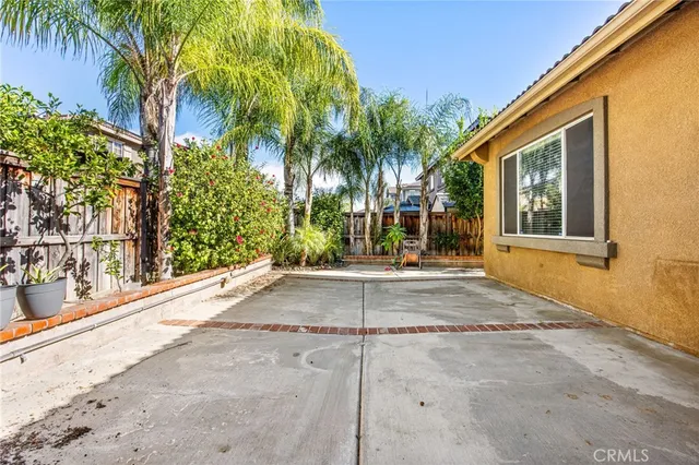 a view of a house with a yard and palm trees