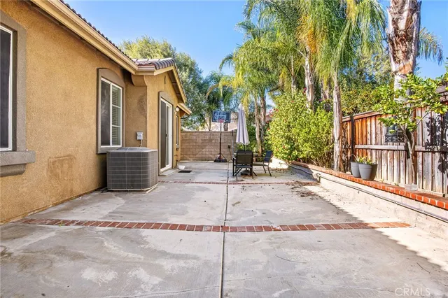 a view of a patio with a table and chairs and potted plants