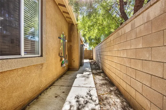 a front view of a house with a garden and tree