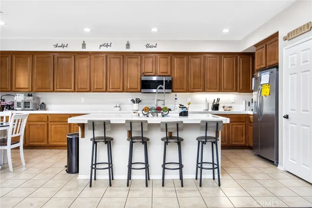 a kitchen with appliances cabinets and a dining table