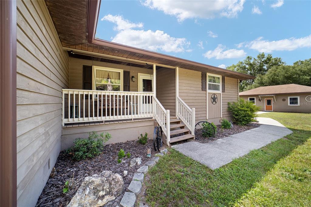 15755 Southwest 90th Avenue Dunnellon, FL 34432 - Photo 6 of 55 a view of a house with backyard and sitting area
