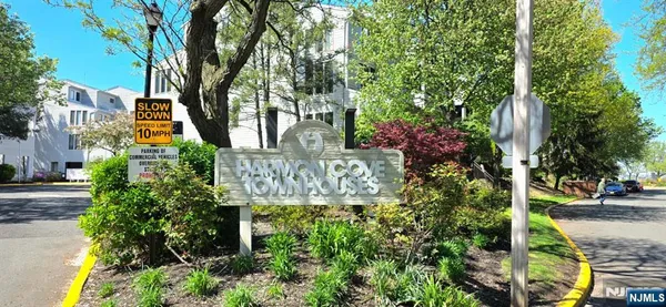 a sign that is sitting in front of flowers