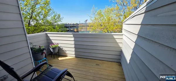 a view of deck with wooden floor and seating space