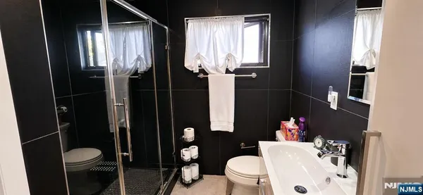 a white toilet sitting next to a bathroom sink