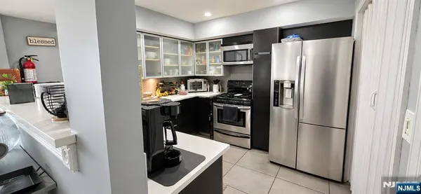 a kitchen with stainless steel appliances a refrigerator and a stove top oven