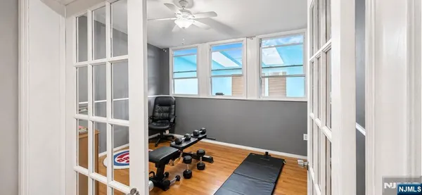 a view of a livingroom with wooden floor and a window
