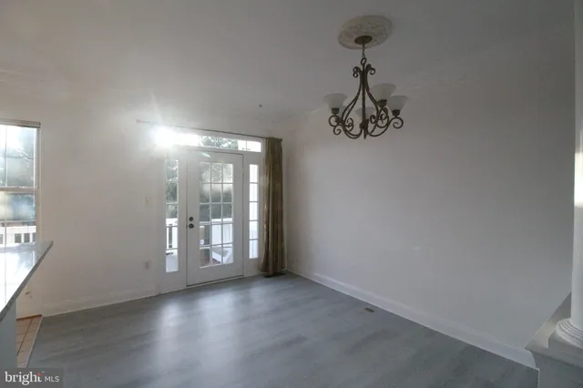 a view of a room with wooden floor and windows