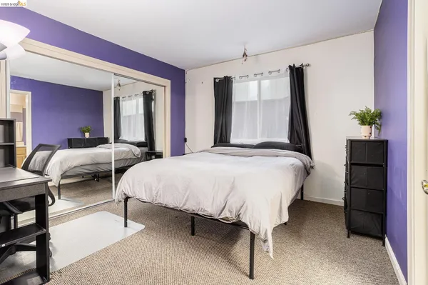 a spacious bedroom with a bed and a table