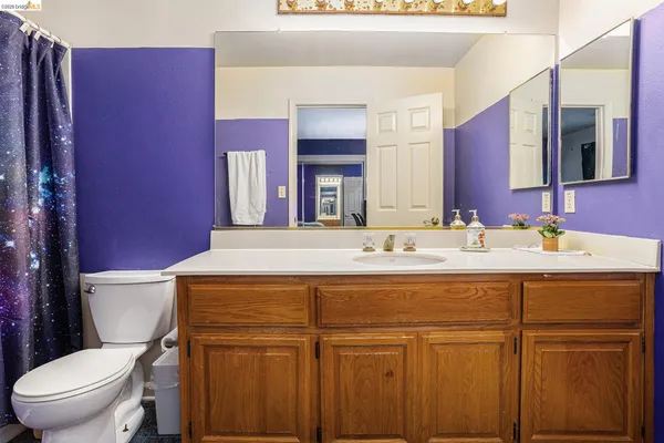 a bathroom with a sink a toilet and mirror