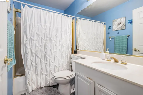 a bathroom with a sink a toilet and a tub