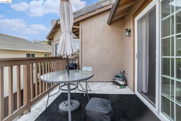 a balcony with table and chairs