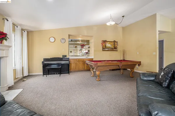 a living room with furniture and a piano