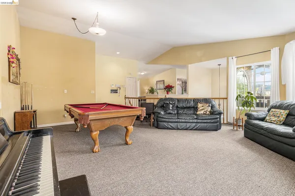 a living room with furniture a table and a chandelier
