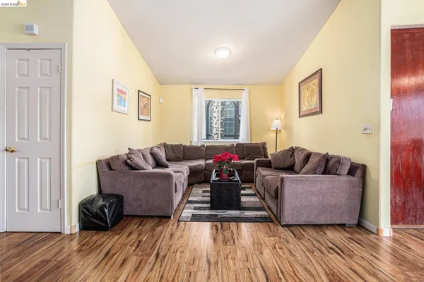 a living room with furniture and a wooden floor