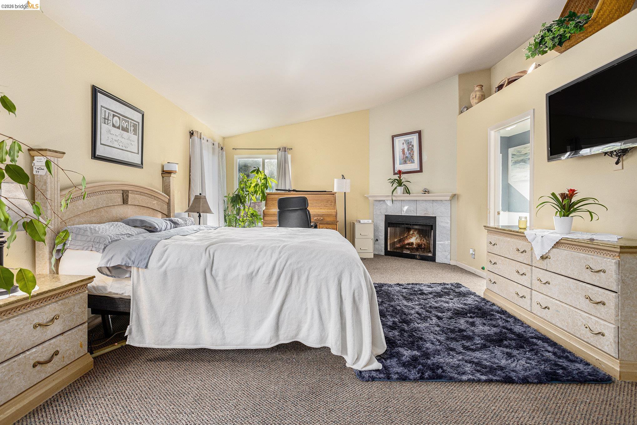 5490 Lenora Road Richmond, CA 94803 - Photo 9 of 22 a spacious bedroom with a bed and a flat screen tv