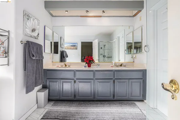 a spacious bathroom with a double vanity sink and a mirror
