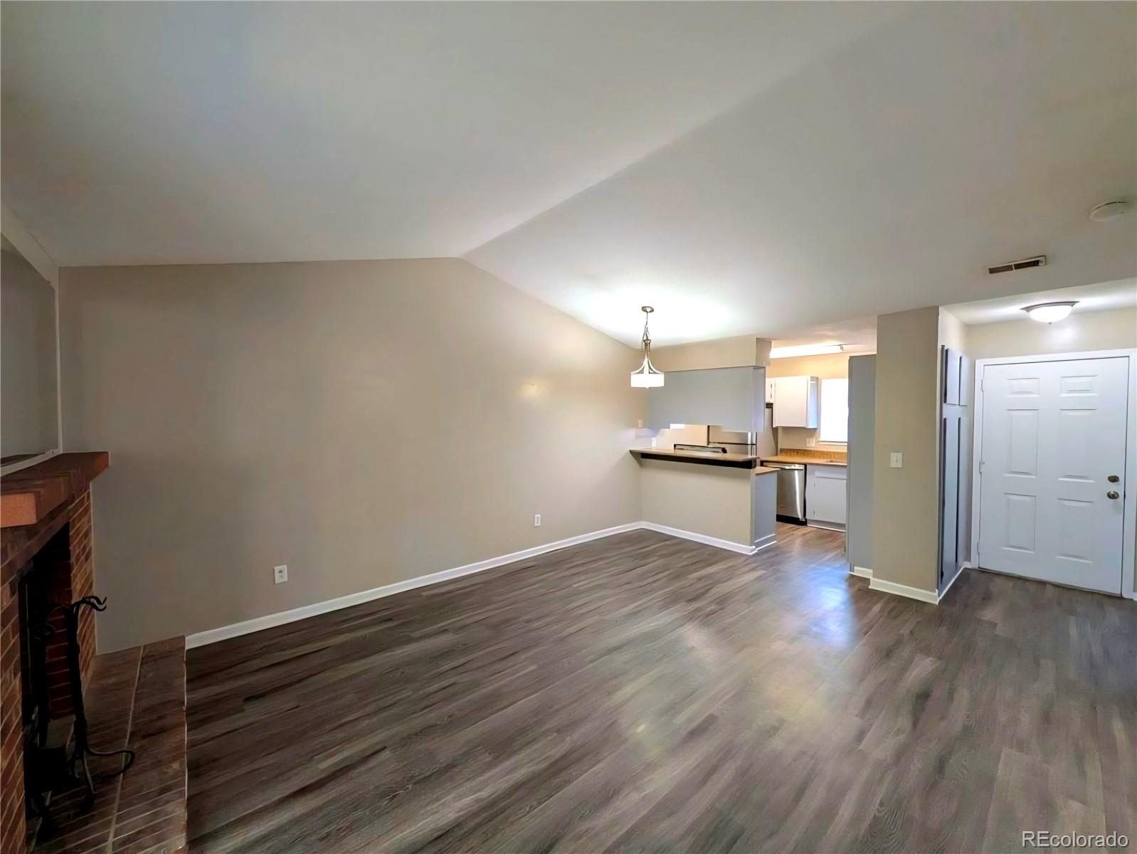 2231 South Buckley Road, Unit 202 Aurora, CO 80013 - Photo 4 of 10 a view of an empty room with wooden floor