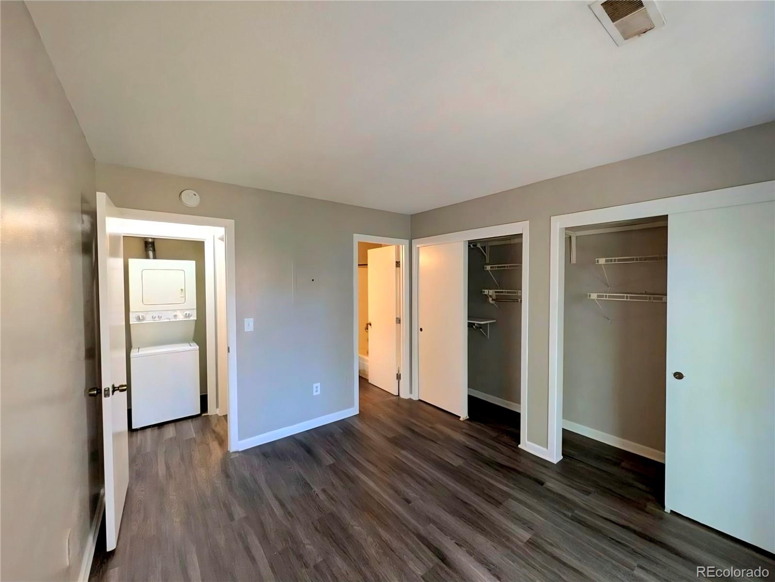 2231 South Buckley Road, Unit 202 Aurora, CO 80013 - Photo 6 of 10 an empty room with wooden floor and closet