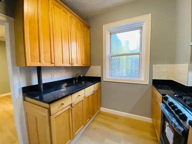 a kitchen that has a sink and a stove in it