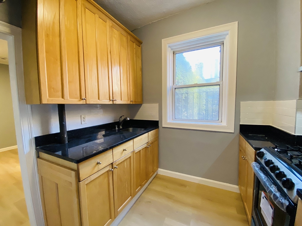 31 Queensberry Street, Unit 19 Boston, MA 02215 - Photo 4 of 6 a kitchen that has a sink and a stove in it