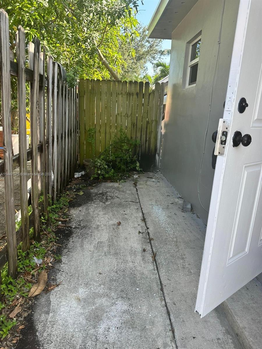 226 Southwest 11th Street, Unit 1 Dania Beach, FL 33004 - Photo 5 of 10 a view of a pathway with a backyard