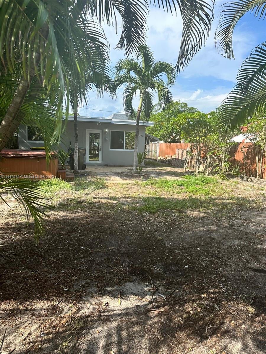 226 Southwest 11th Street, Unit 1 Dania Beach, FL 33004 - Photo 8 of 10 a view of a house with a yard