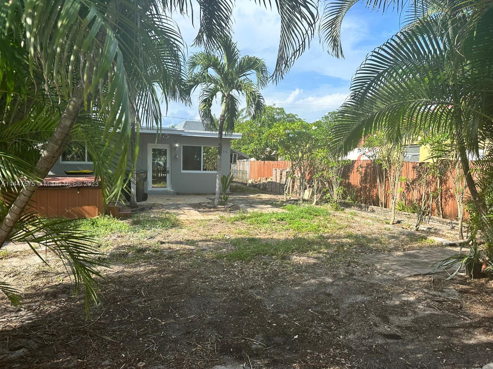 226 Southwest 11th Street, Unit 1 Dania Beach, FL 33004 - Photo 9 of 10 a view of a house with a yard