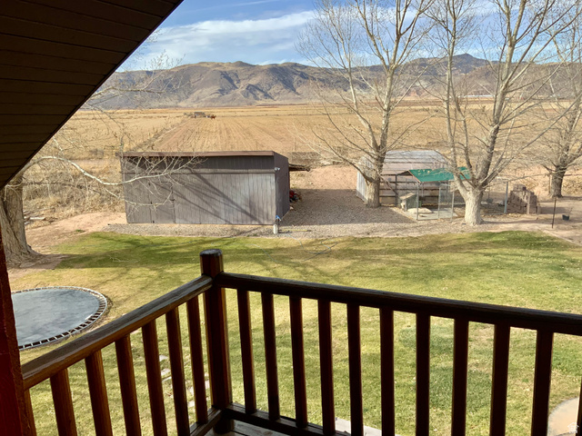 76 Highway 118 Monroe, UT 84754 - Photo 73 of 76 Wooden terrace with a lawn, a mountain view, a trampoline, and an outbuilding